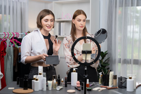 Woman influencer shoot live streaming vlog video review makeup utmost social media or blog. Happy young girl with cosmetics studio lighting for marketing recording session broadcasting online.の写真素材