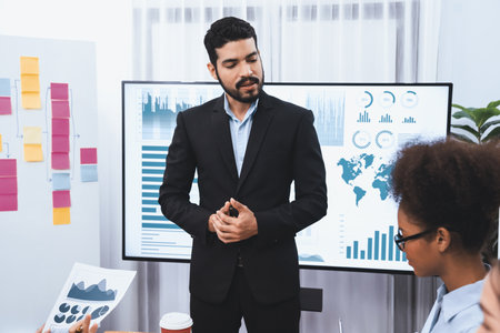 Businessman presenting data analysis dashboard display on TV screen in modern meeting for marketing...