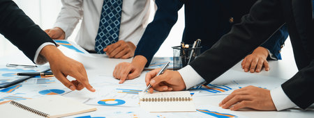 Business people in group meeting in formal attire share idea discussing report for company profit in...