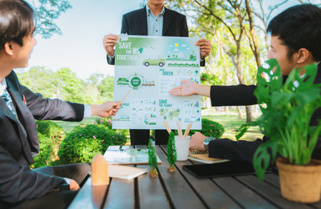 Group of asian business people presenting environmentally friendly development plan and sustainable technology project for greener future, establishing outdoor eco business office at natural park.Gyreの写真素材