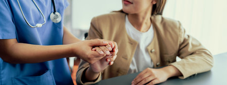 Doctor or nurse providing compassionate healthcare consultation while holding young patient hand for being supportive and professional as medical staff in doctor clinic or hospital office. Neotericの写真素材