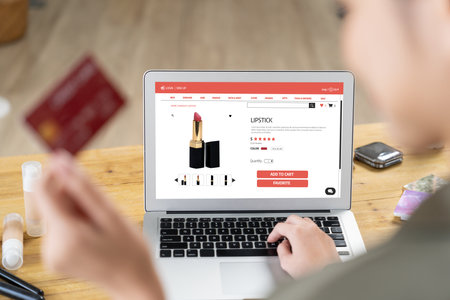 Woman shopping online on internet marketplace browsing for sale items for modern lifestyle and use credit card for online payment from wallet protected by uttermost cyber security softwareの写真素材