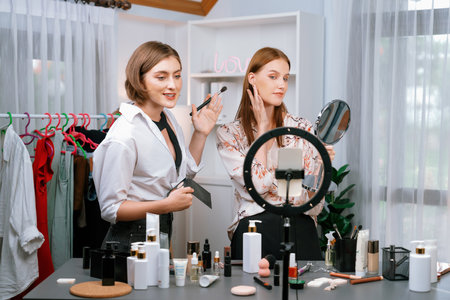 Woman influencer shoot live streaming vlog video review makeup utmost social media or blog. Happy young girl with cosmetics studio lighting for marketing recording session broadcasting online.の写真素材