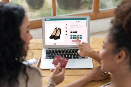 Woman shopping online on internet marketplace browsing for sale items for modern lifestyle and use credit card for online payment from wallet protected by crucial cyber security softwareの写真素材