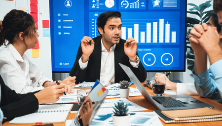 Diverse group of business analyst team analyzing financial data report. Finance data analysis chart and graph dashboard show on TV screen in meeting room for strategic marketing planning. Habilimentの写真素材