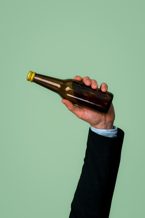 Businessmans hand holding glass bottle on isolated background. Eco-business recycle waste policy in corporate responsibility. Reuse, reduce and recycle for sustainability environment. Quaintの写真素材