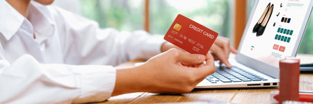 Woman shopping online on internet marketplace browsing for sale items for modern lifestyle and use credit card for online payment from wallet protected by uttermost cyber security softwareの写真素材