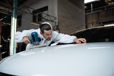 Automotive repair shop, concept of car detailing and polishing by professional car service worker with precision using orbital polisher machine creative captivating automotive flourish . Oxusの写真素材