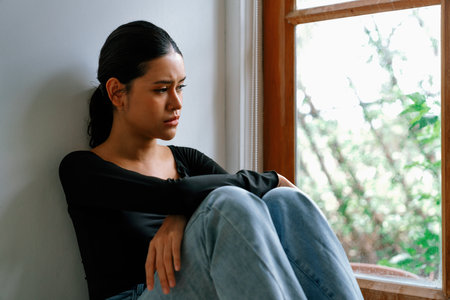 Depressed young Asian woman with mental health problem in mind need uttermost treatment from overthinking fatigue, disruptive thought, dissocial, anxiety and other mental health disorders .の写真素材