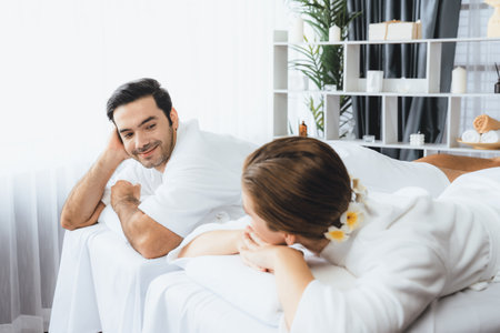Caucasian couple customer enjoying relaxing anti-stress spa massage and pampering with beauty skin recreation leisure in day light ambient salon spa at luxury resort or hotel. Quiescentの写真素材