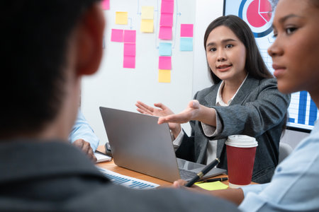Young asian businesswoman presenting data analysis dashboard on TV screen in modern meeting. Business presentation with group of business people in conference room. Concordの写真素材