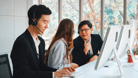 Business people wearing headset working in office to support remote customer or colleague. Call center, telemarketing, customer support agent provide service on telephone video conference call. Jivyの写真素材