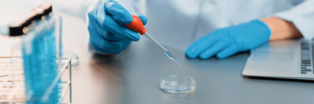 Scientist conduct chemical experiment in medical laboratory, carefully drop precise amount of liquid from pipette into test tube for vaccine drug or antibiotic development. Neotericの写真素材