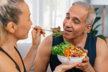Healthy senior couple in sportswear with a bowl of fruit and vegetable. Healthy cuisine nutrition and vegan lifestyle for fitness body physique concept. Cloutの写真素材