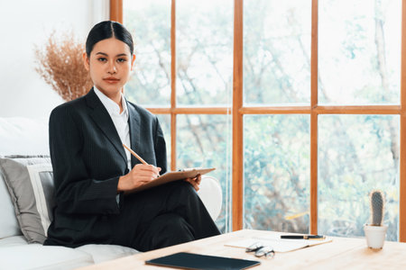 Psychologist woman in clinic office professional portrait with friendly smile feeling inviting for patient to visit the psychologist. The experienced and confident psychologist is uttermost specialistの写真素材
