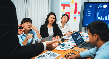 Diverse group of business analyst team analyzing financial data report. Finance data analysis chart and graph dashboard show on TV screen in meeting room for strategic marketing planning. Habilimentの写真素材
