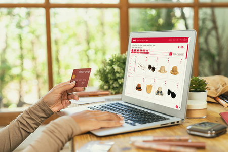 Woman shopping online on internet marketplace browsing for sale items for modern lifestyle and use credit card for online payment from wallet protected by crucial cyber security softwareの写真素材