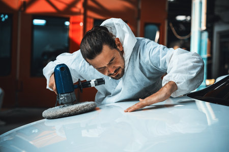 Automotive repair shop, concept of car detailing and polishing by professional car service worker with precision using orbital polisher machine creative captivating automotive flourish . Oxusの写真素材