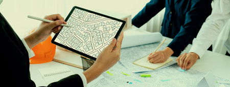 Worker, architect and engineer work on real estate construction project oratory planning with cartography and cadastral map of urban town area to guide to construction developer business plan of cityの写真素材