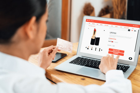 Woman shopping online on internet marketplace browsing for sale items for modern lifestyle and use credit card for online payment from wallet protected by uttermost cyber security softwareの写真素材