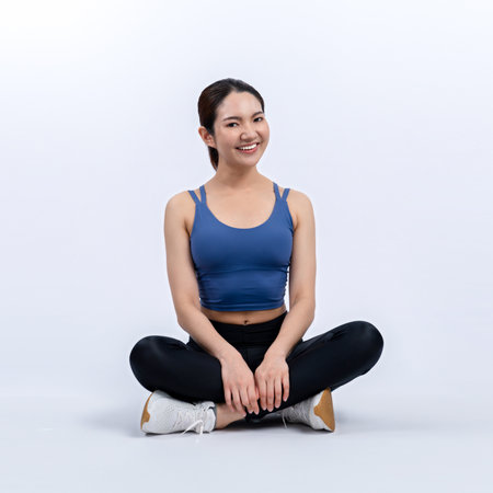 Full body asian woman in sportswear portrait, smiling and posing cheerful gesture. Workout training with attractive girl engage in her pursuit of healthy lifestyle. Isolated background Vigorousの写真素材