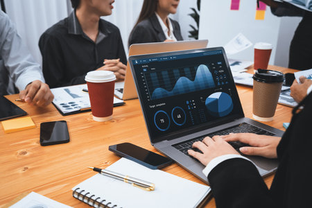 Multiracial analyst team use BI Fintech software to analyze financial data on meeting table. Financial dashboard data display on laptop screen with analyzed chart for marketing indication. Concordの写真素材