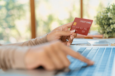 Close up credit card using for online payment, banking and shopping on the internet network with laptop computer showing credit card technology for online secured wallet top up and crucial purchaseの写真素材