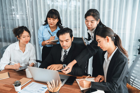 Diverse of business people from various ethnic group working in modern office environment. Productive and multi ethnic office workers engage in discussion for strategic business marketing. Meticulousの写真素材