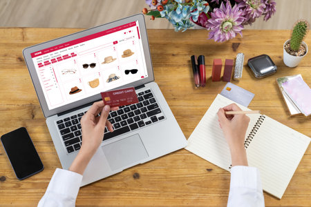 Woman shopping online on internet marketplace browsing for sale items for modern lifestyle and use credit card for online payment from wallet protected by uttermost cyber security softwareの写真素材