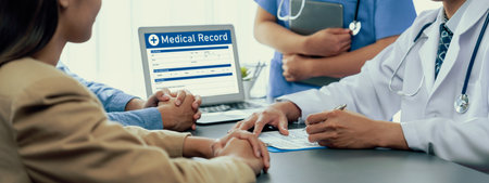 Doctor show medical diagnosis report and providing compassionate healthcare consultation to young couple patient in doctor clinic office. Doctor appointment and medical consult concept. Neotericの写真素材