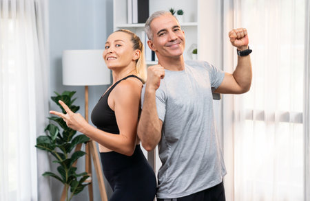 Athletic and sporty senior couple portrait in sportswear with successful or celebrating after...