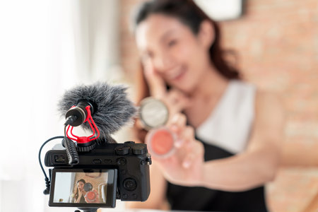 Asian Woman influencer shoot live streaming vlog video review makeup uttermost social media or blog....