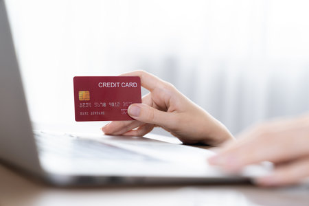 Close up credit card using for online payment, banking and shopping on the internet network with laptop computer showing credit card technology for online secured wallet top up and utmost purchaseの写真素材