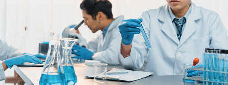 Group of dedicated scientist conduct chemical experiments and research in medical lab as...