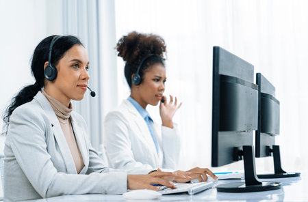 Business people wearing headset working in office to support remote customer or colleague. Call center, telemarketing, customer support agent provide service on telephone video conference call crucialの写真素材