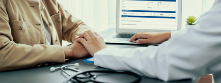 Doctor show medical diagnosis report and providing compassionate healthcare consultation while holding young patient hand for being supportive and professional in doctor clinic office. Neotericの写真素材