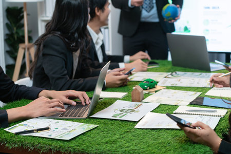 Businessman leader give presentation on eco-friendly implementation in order to reduce CO2 emission and make sustainable ecology for greener future with corporate environmental regulation. Quaintの写真素材
