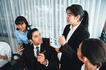 Diverse of business people from various ethnic group working in modern office environment. Productive and multi ethnic office workers engage in discussion for strategic business marketing. Habilimentの写真素材