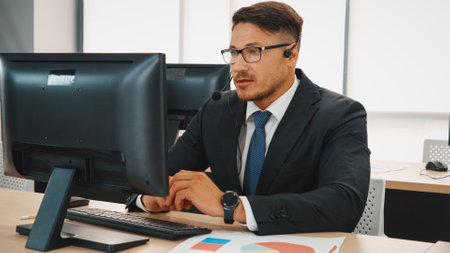 Business people wearing headset working in office to support remote customer or colleague. Call center, telemarketing, customer support agent provide service on telephone video conference call. Jivyの写真素材