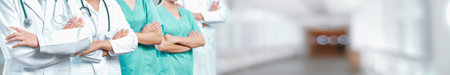 Confident medical staff team with doctor nurse and healthcare specialist professions people in blurry hospital corridor background. Medical and healthcare community in panoramic banner. Neotericの写真素材