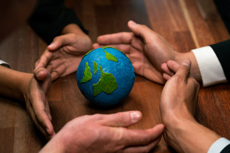 Top view business people holding Earth together in synergy as team building to utilize eco regulation for environmental protection by reducing CO2 emission to save Earth. Quaintの写真素材
