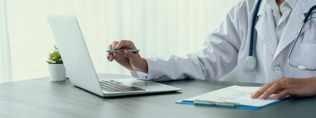 Doctor carefully review detailed medical report with laptop and diagnosing illness for effective healthcare treatment plan for patient in doctor office. Professional medical evaluation. Neotericの写真素材