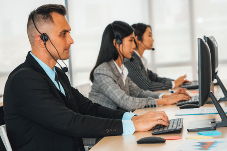 Business people wearing headset working in office to support remote customer or colleague. Call center, telemarketing, customer support agent provide service on telephone video conference call. Jivyの写真素材