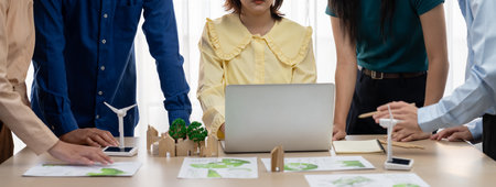 Professional business team prepare to present green business on table with windmill presented using...