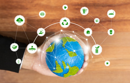 Businessmans hand holding Earth globe symbolize corporate commitment to ESG or CSR to reduce carbon emission and adopting eco-friendly clean business to minimize environmental impact. Relianceの写真素材