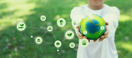 Focused planet Earth globe with eco friendly icon hold by blur little boy, symbolize environmental...