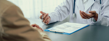 Doctor show medical diagnosis report and providing compassionate healthcare consultation to young patient in doctor clinic office. Doctor appointment and medical consult concept. Neotericの写真素材