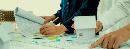 Worker, architect and engineer work on real estate construction project oratory planning with...