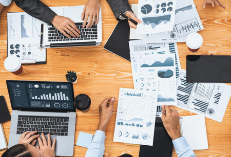 Multiracial analyst team use BI Fintech software to analyze financial data on meeting. Top view...