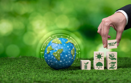 Businessman place net zero cube on top of stack cubes, symbolizing green business commitment to ESG...